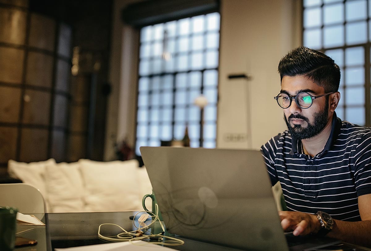 man sitting at laptop